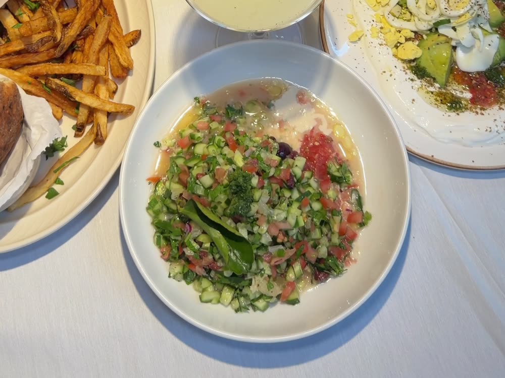 A spread of small salads and dips on the table